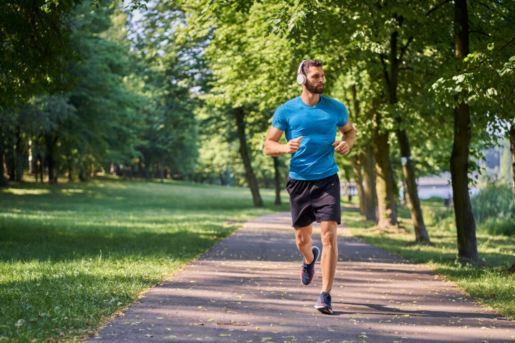 A man jogging in the morning in a park